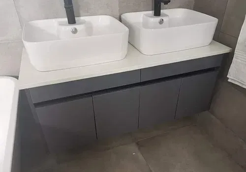Finished bathroom vanity with double basins and modern cabinetry