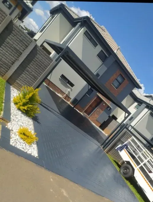Modern Gauteng home with a paved driveway and carport